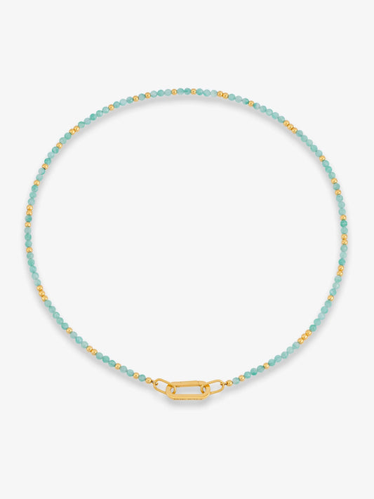 Necklace with blue beads and gold clasp on a white background