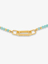 Gold bracelet with turquoise beads on a white background