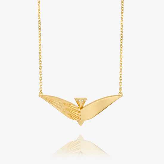 Gold necklace with a unique pendant on a white background