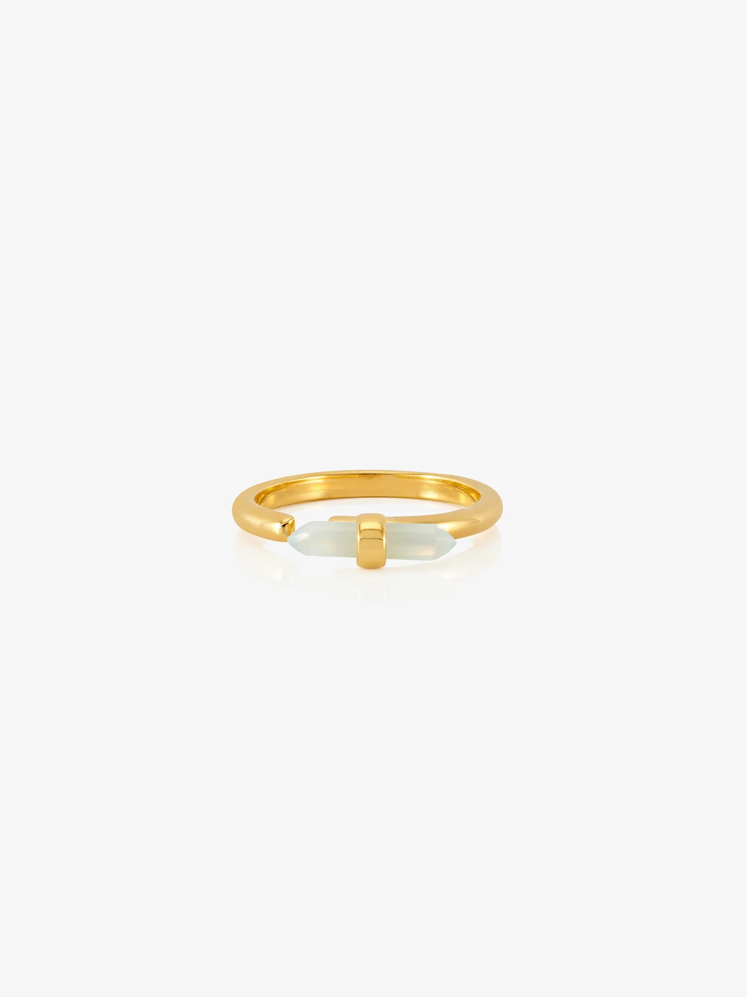 Gold ring with a white stone on a white background
