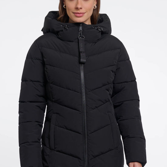 Woman wearing a black puffer coat on a white background