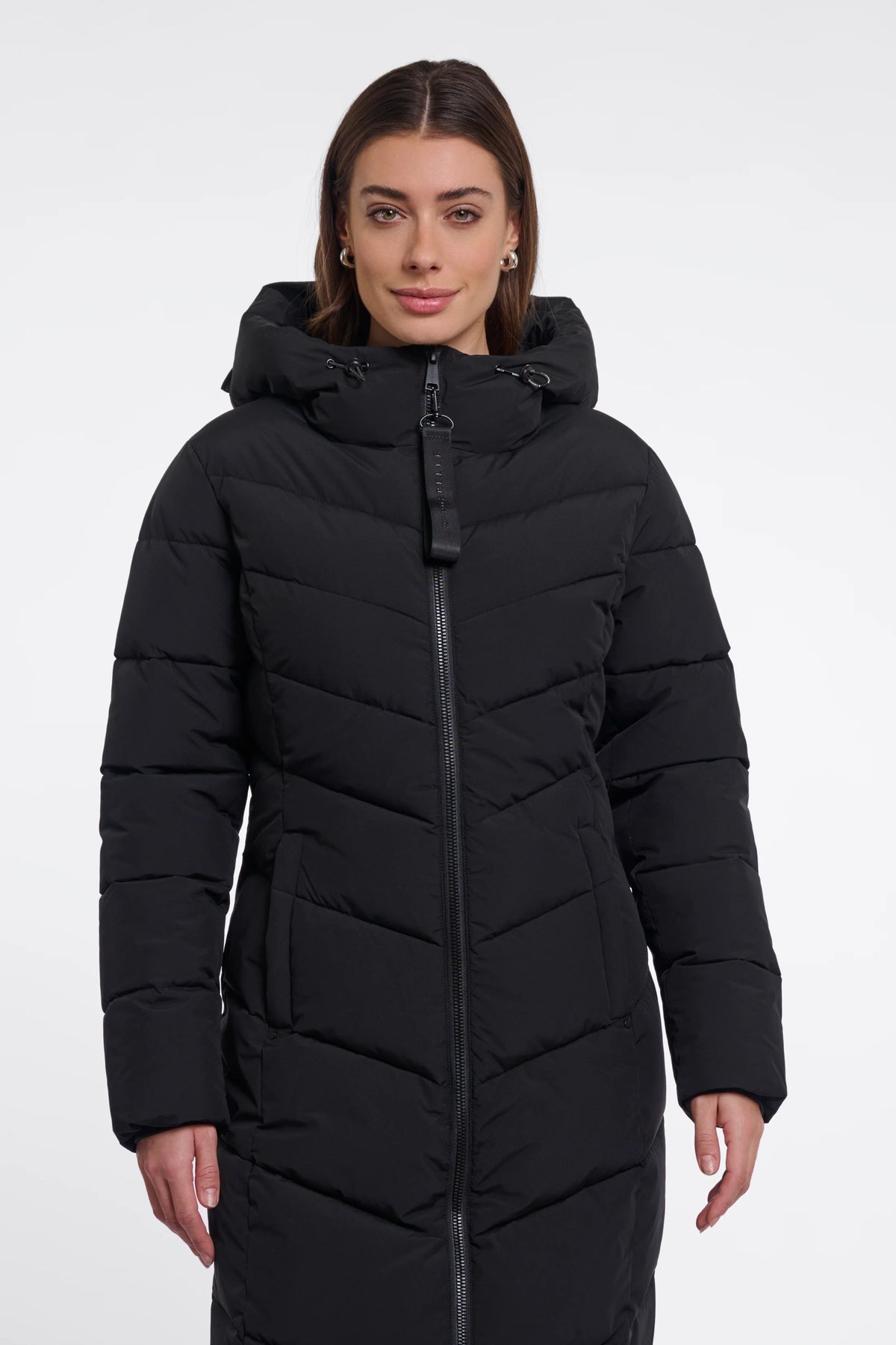 Woman wearing a black puffer coat on a white background