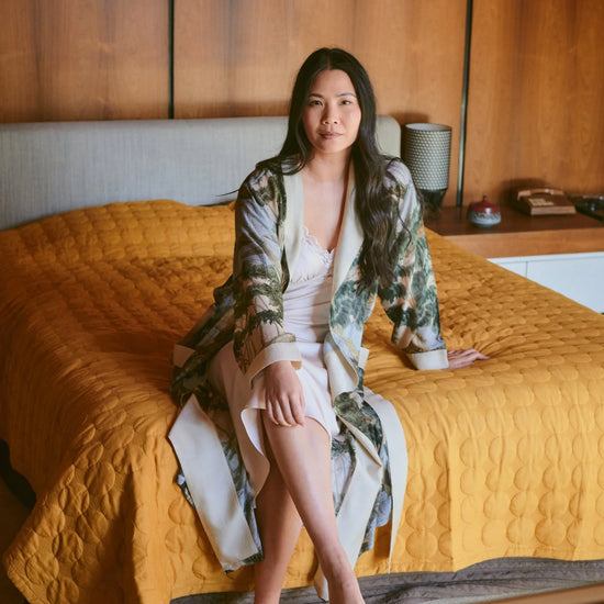 dressing gown with beige lapels/edging and green/blue tree and rivers print from one hundred stars model shot