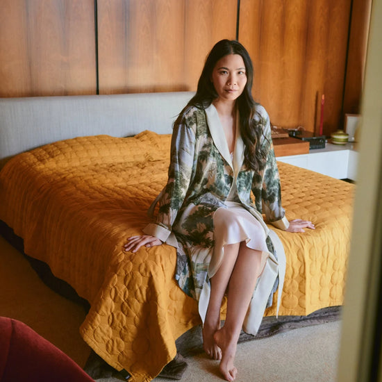 dressing gown with beige lapels/edging and green/blue tree and rivers print from one hundred stars model shot