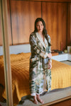 dressing gown with beige lapels/edging and green/blue tree and rivers print from one hundred stars model shot