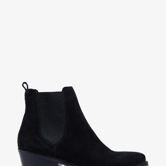 Side view of lack suede boot on white background