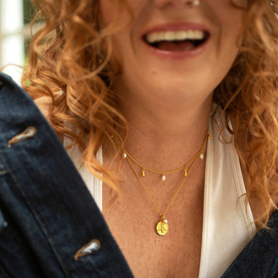 Gold bee coin pendant necklace with small rice pearl on gold chain