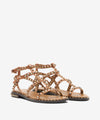 Pair of tan sandals with metallic accents on a white background