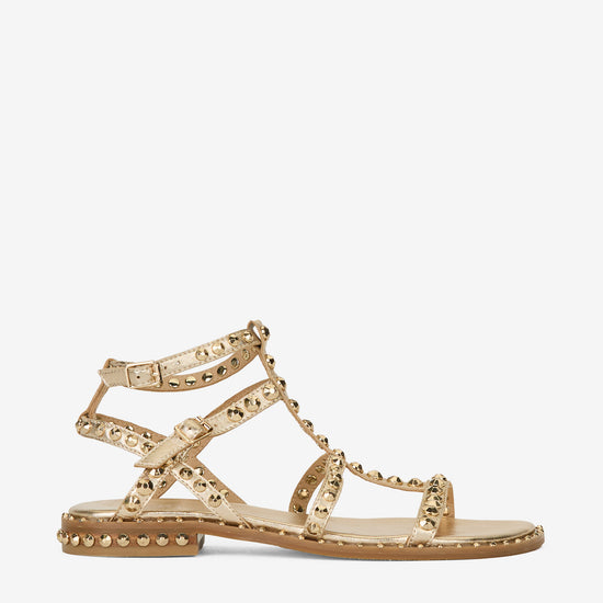 Gold sandal with gold studs on a white background side profile 