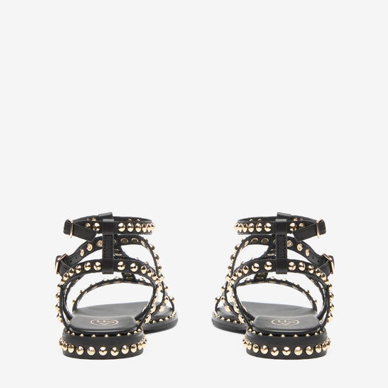 Black sandal with gold studs on a white background rear view
