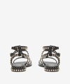 Black sandal with gold studs on a white background rear view