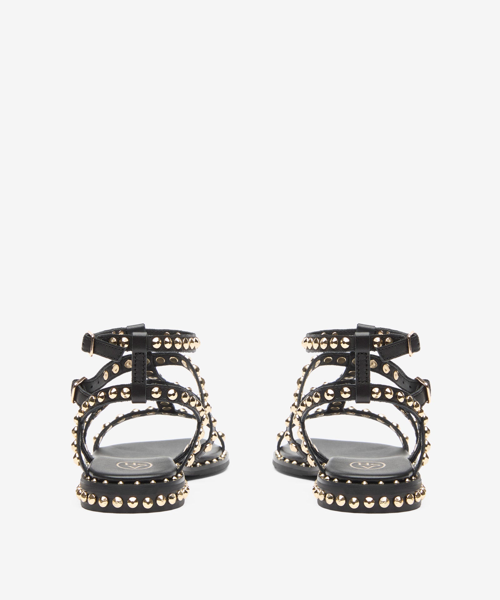 Black sandal with gold studs on a white background rear view