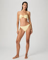 Woman wearing a yellow bikini from Paige on a white background