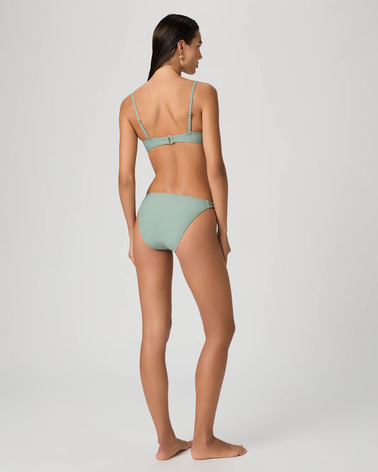 Woman wearing a light green bikini from Paige on a white background