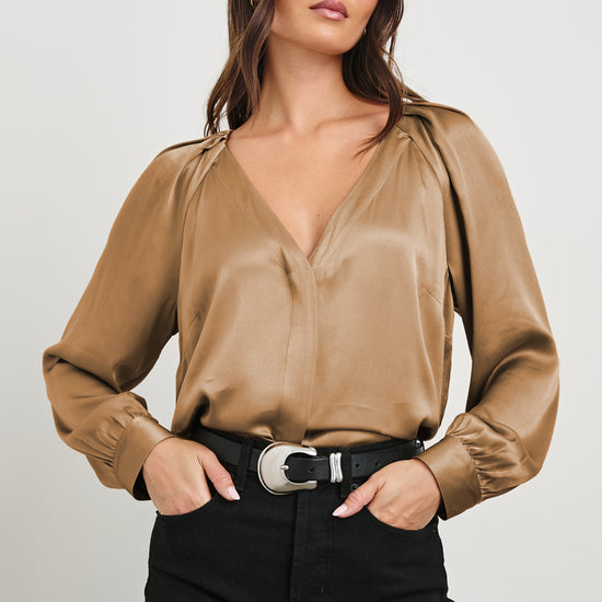 Camel satin viscose blouse with a v neck and long sleeves on model paired with jeans