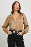 Camel satin viscose blouse with a v neck and long sleeves on model paired with jeans