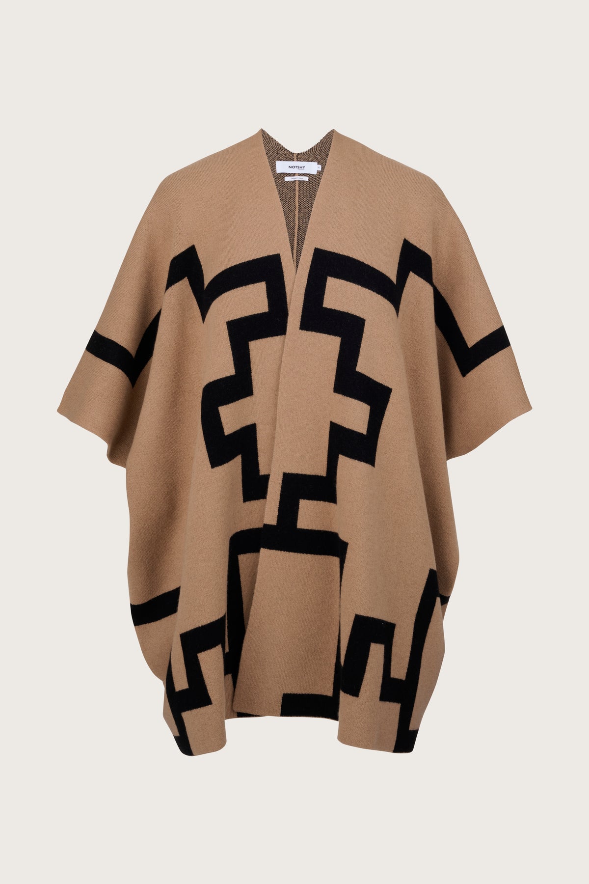 Beige cape with black geometric knitted all over pattern