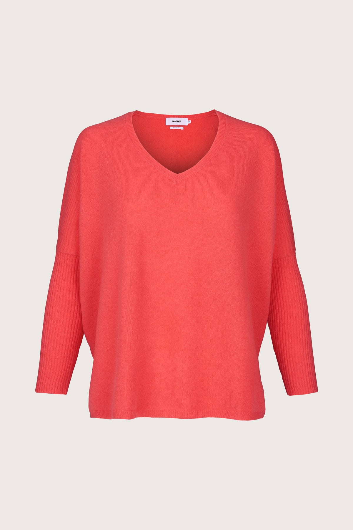 Coral coloured cashmere jumper with a v neck and long rib sleeves