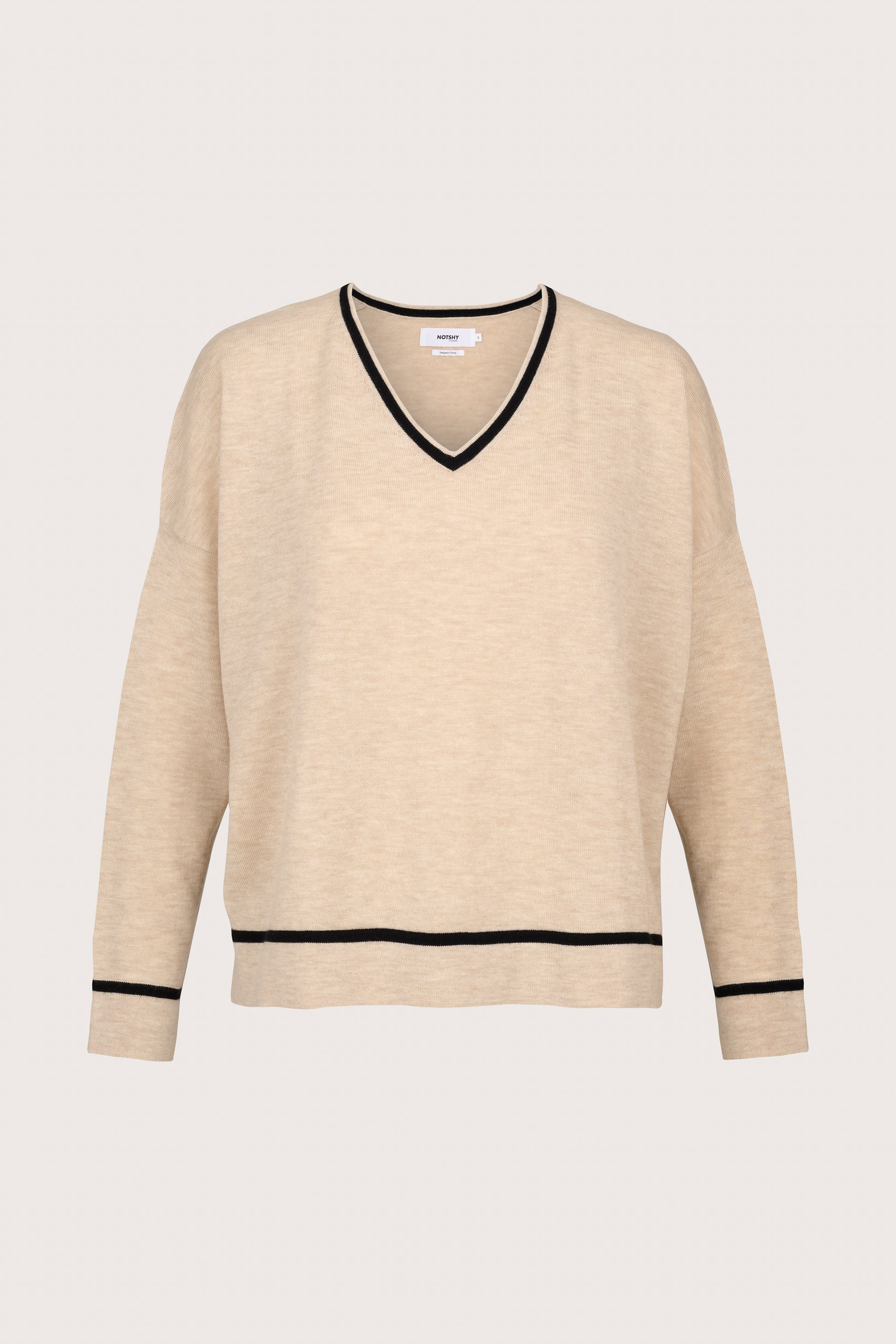 beige v neck jumper with black piping along cuffs, hem and neck