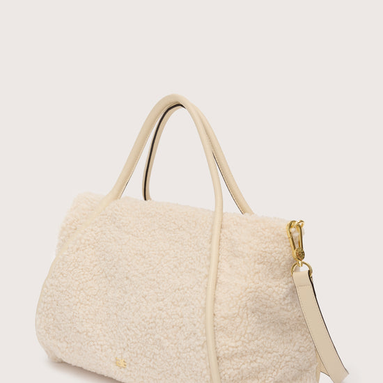 Side view of faux shearling bag