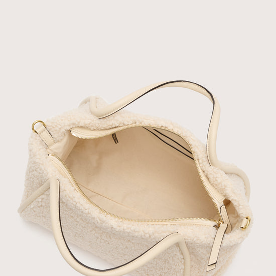 Internal shot of cream faux fur bag