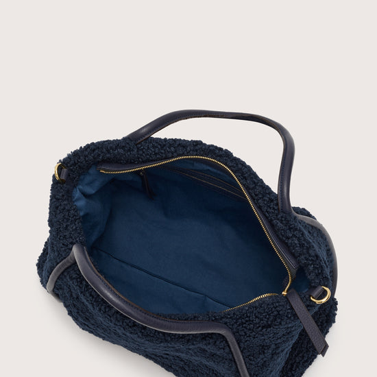 Internal shot of navy faux shearling bag