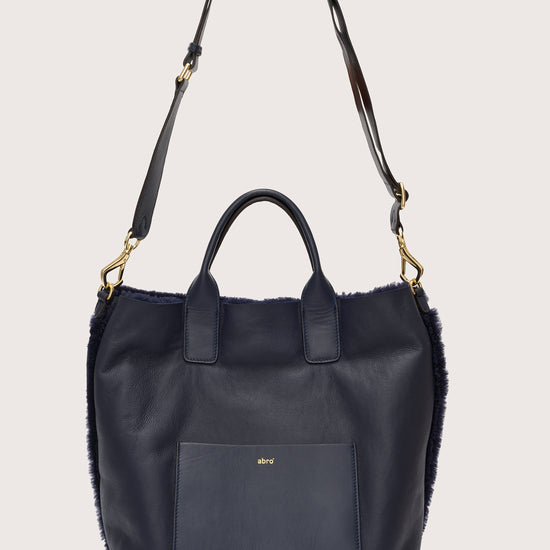 Reversible shearling navy bag with cross body bag