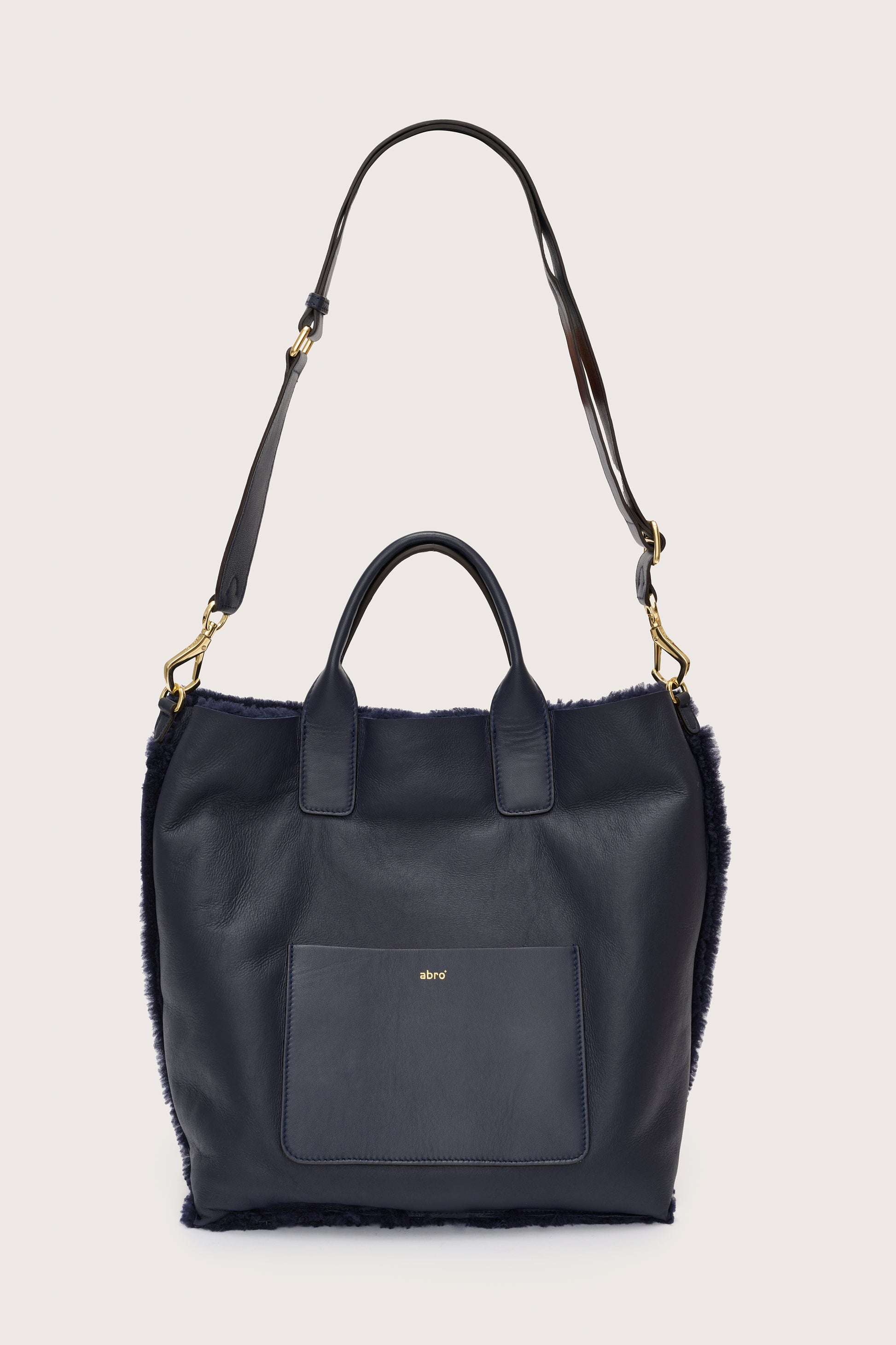 Reversible shearling navy bag with cross body bag