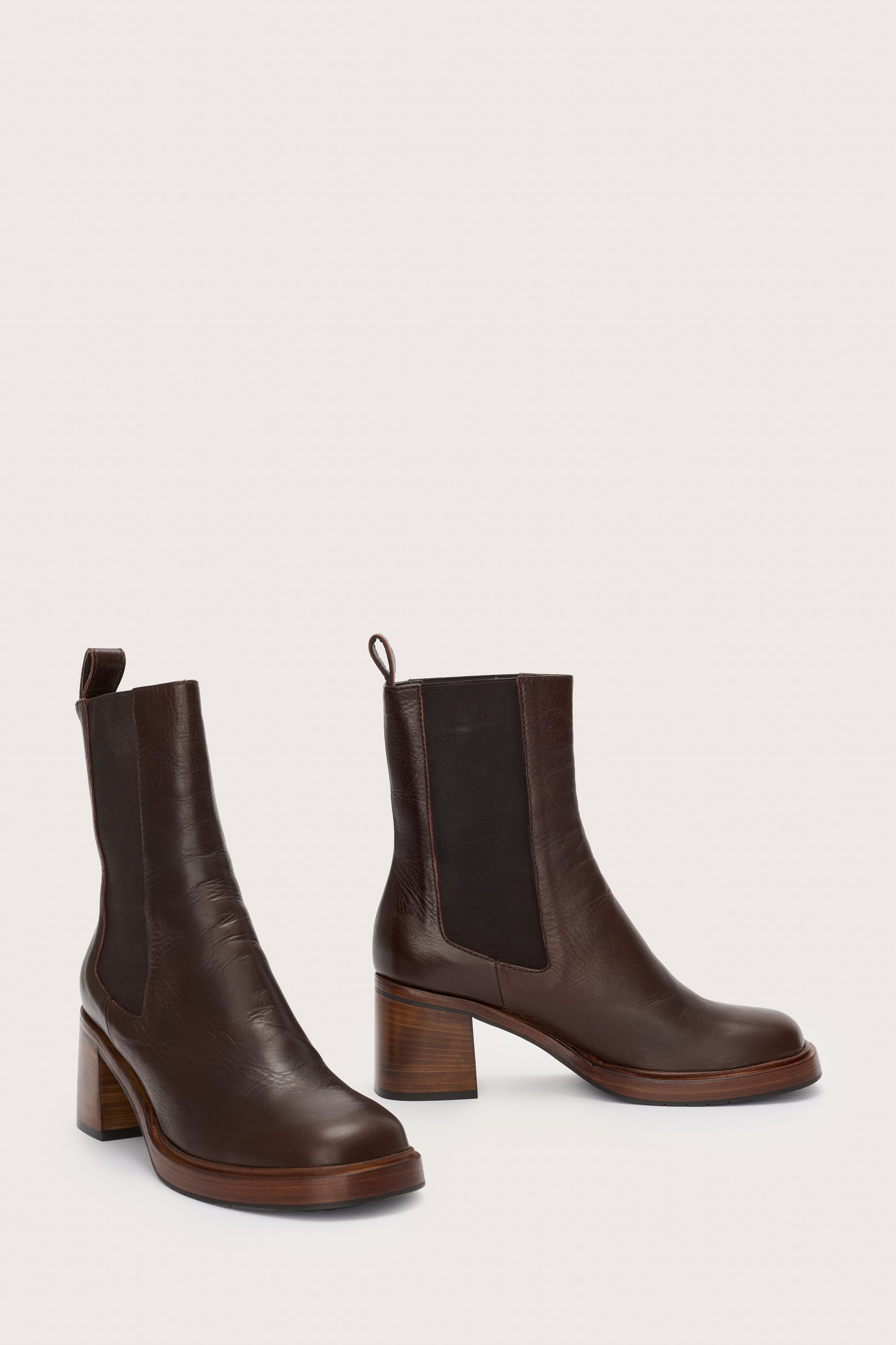 Side view of brown leather boot with block heel