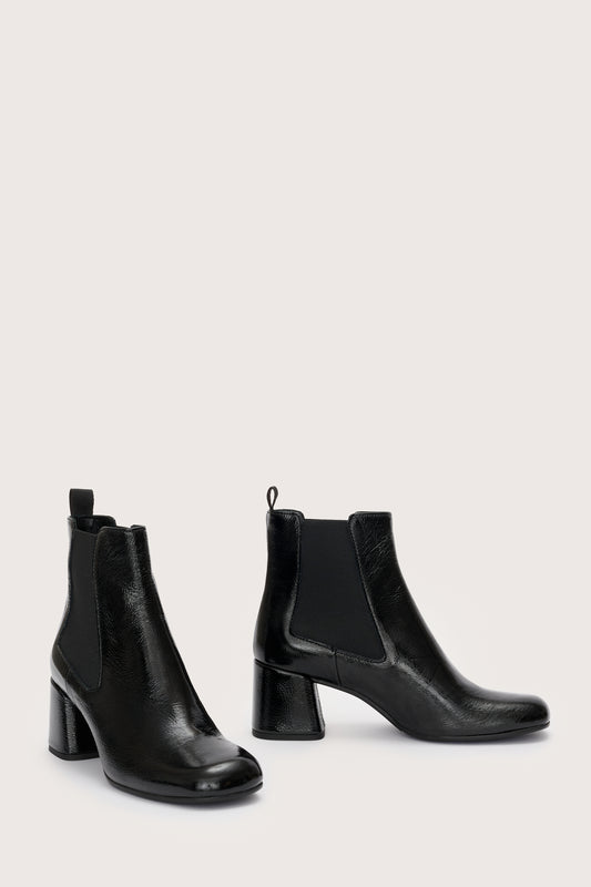 Side view of black patent leather boot with  block heel