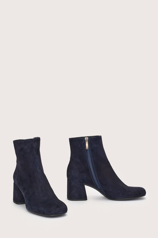 Side view of navy suede boots with side zip