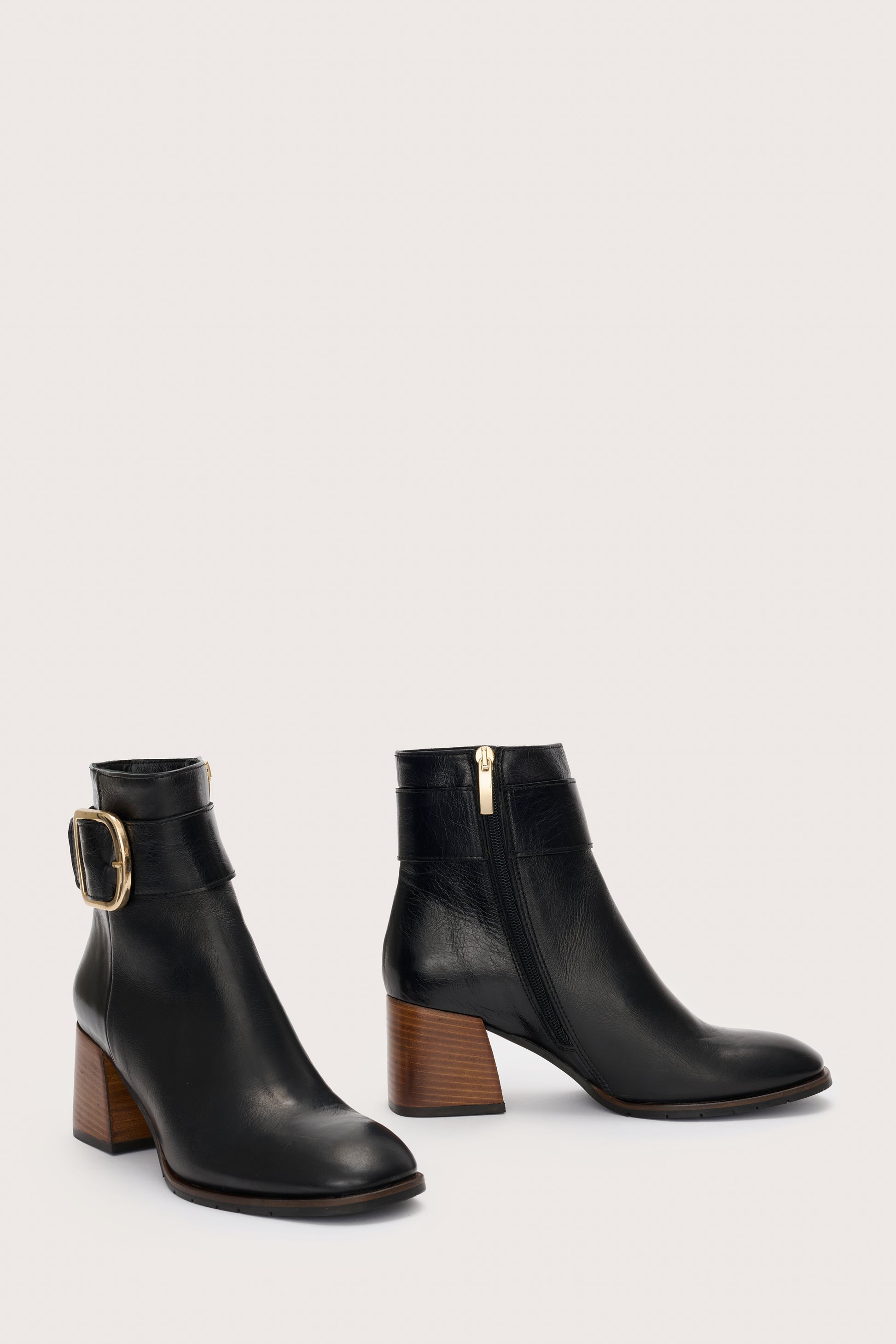 Black Italian leather boot with gold buckle at the ankle