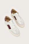 Top view of white Italian leather trainers with maroon leather details