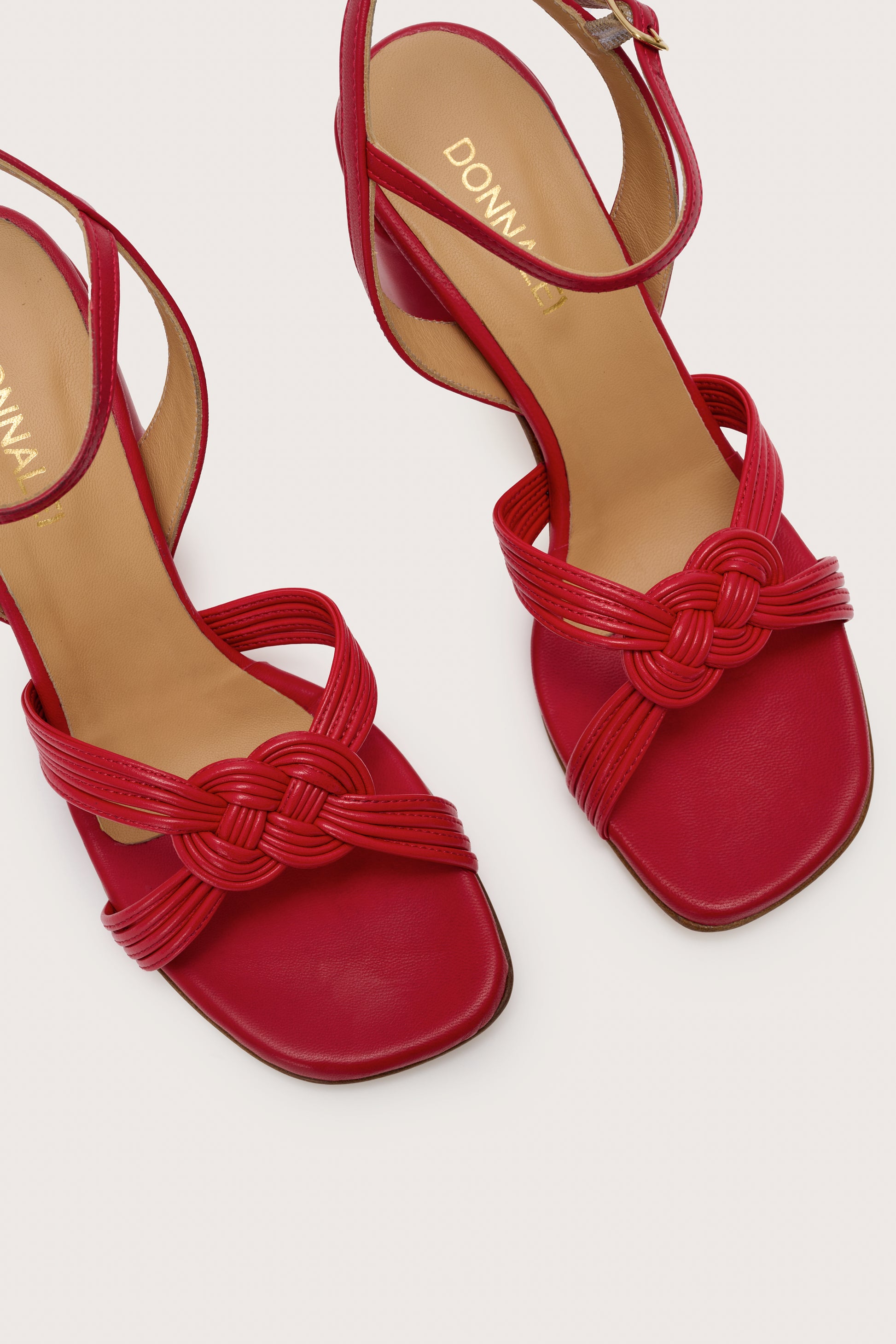 Close up view of the toes on the red leather sandals