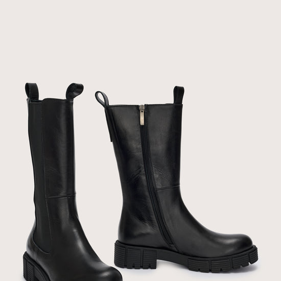 Side view of tall  black leather boots with side zip