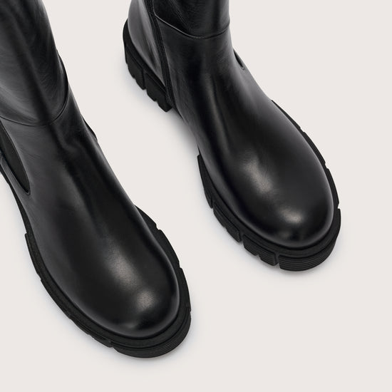 Close up of the toe of the tall black chelsea boot with side zip