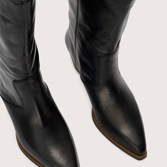 black leather cowboy boots birds eye view 