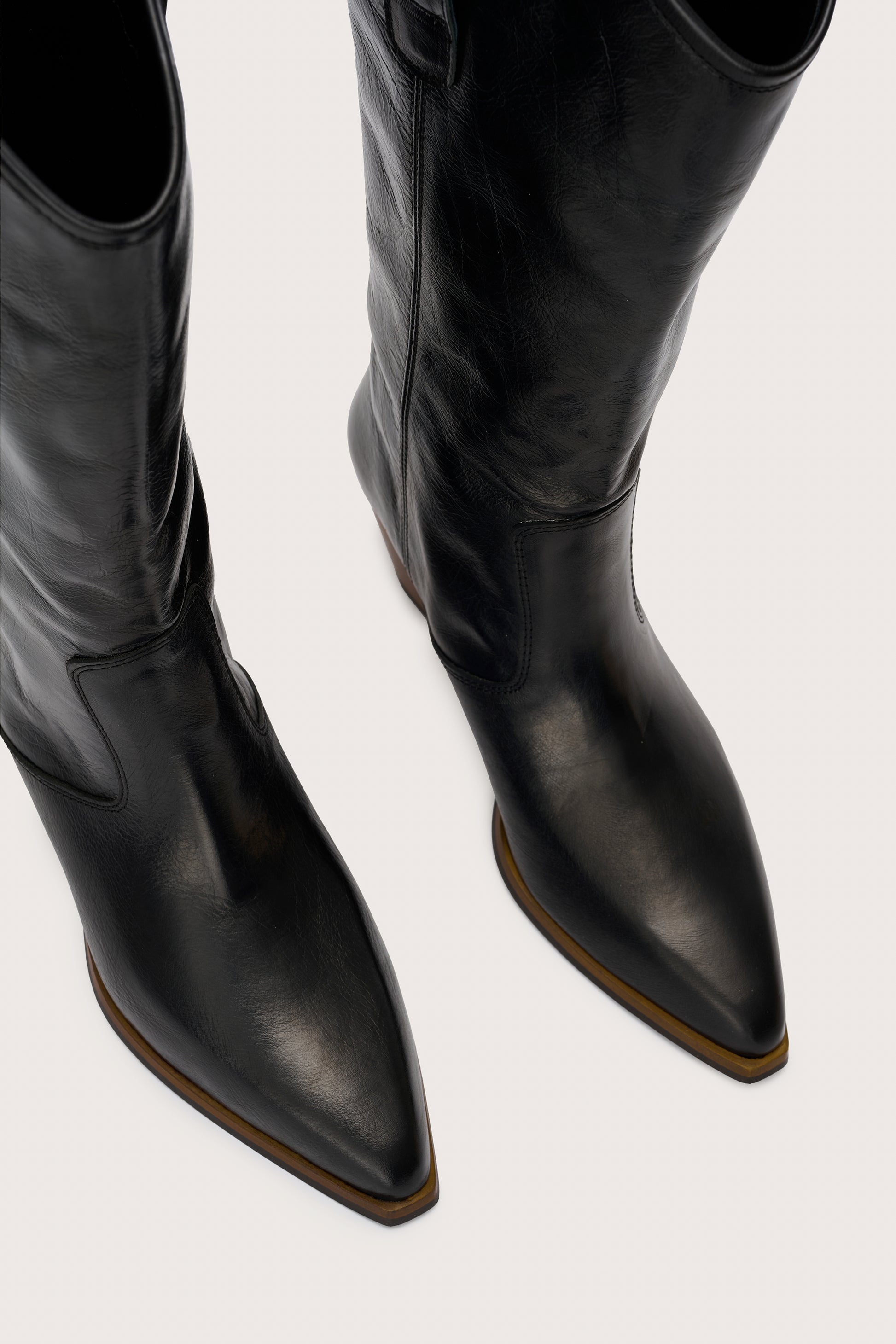 black leather cowboy boots birds eye view 