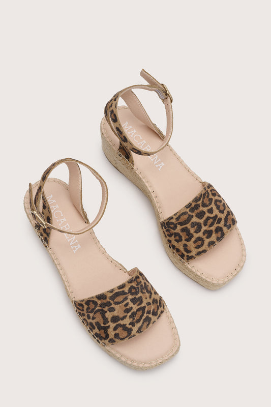 leopard print flat platform sandals with ankle strap and woven bottom birds eye view 