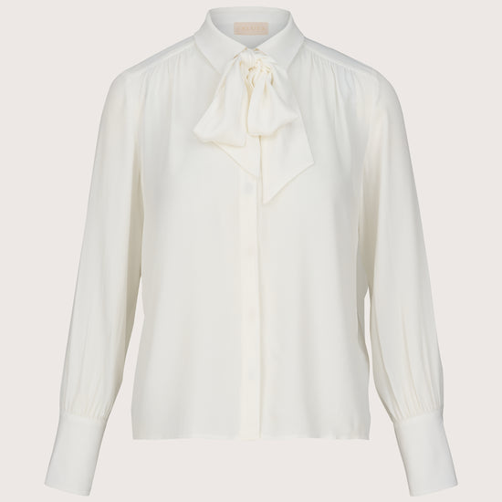 White blouse with a bow tie on a light gray background