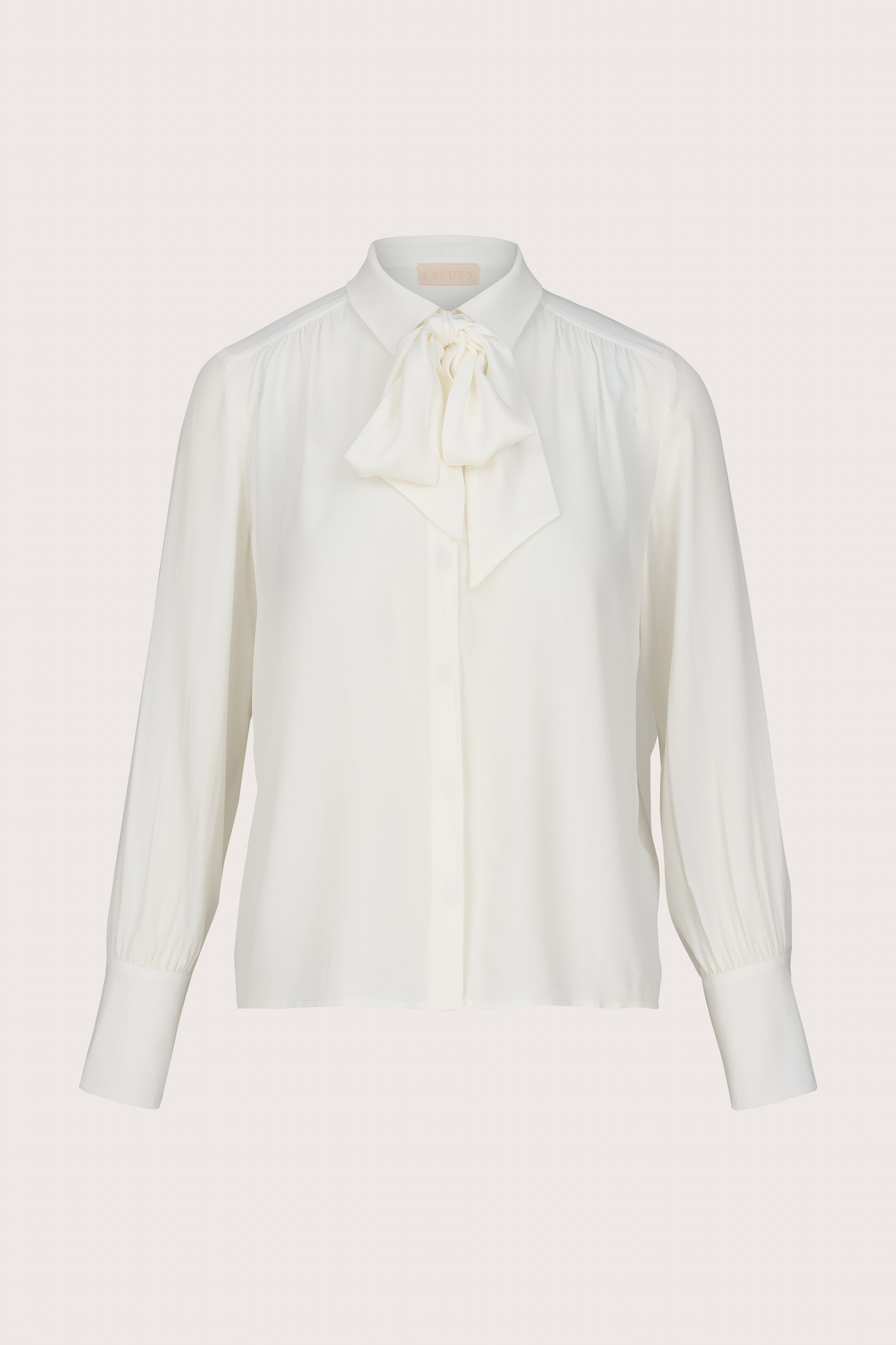 White blouse with a bow tie on a light gray background