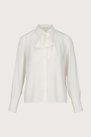 White blouse with a bow tie on a light gray background