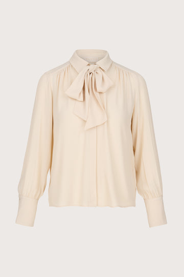 Beige blouse with a bow tie on a light gray background