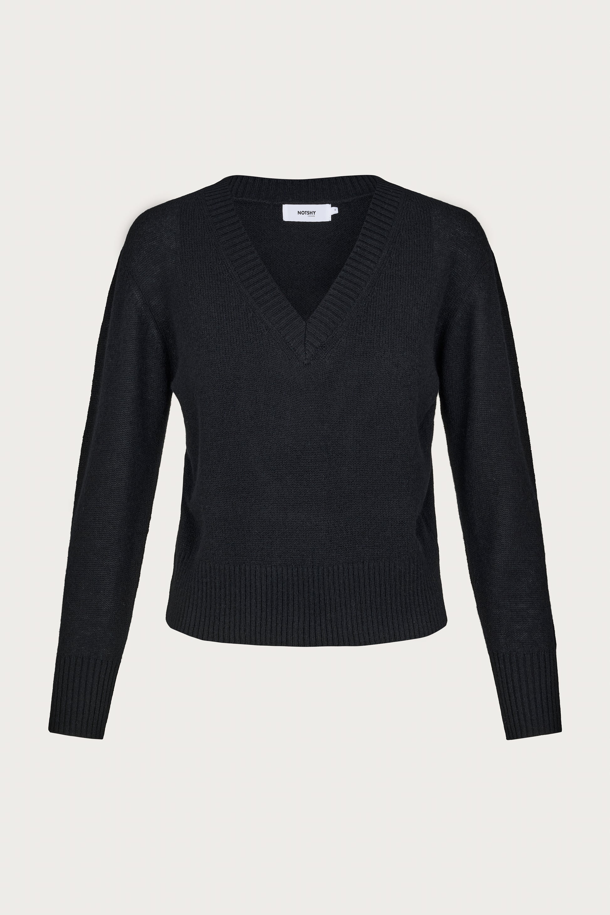 Black cashmere v neck sweater on a light gray background
