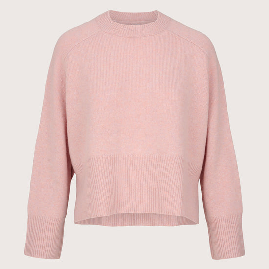 Pink cashmere sweater on a light gray background