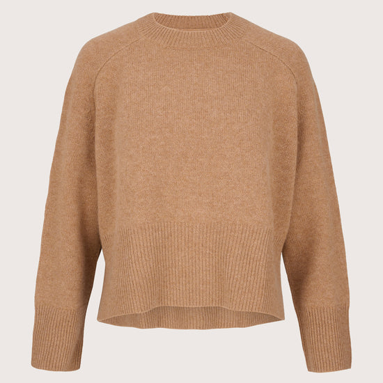 Camel cashmere sweater on a light beige background
