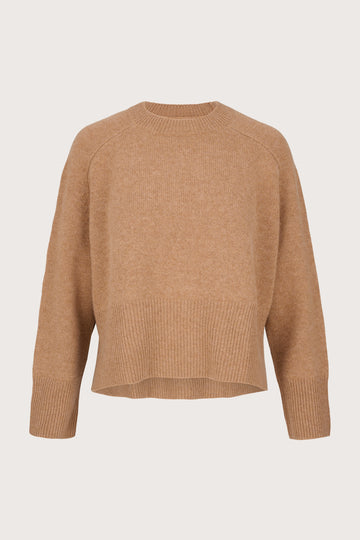Camel cashmere sweater on a light beige background