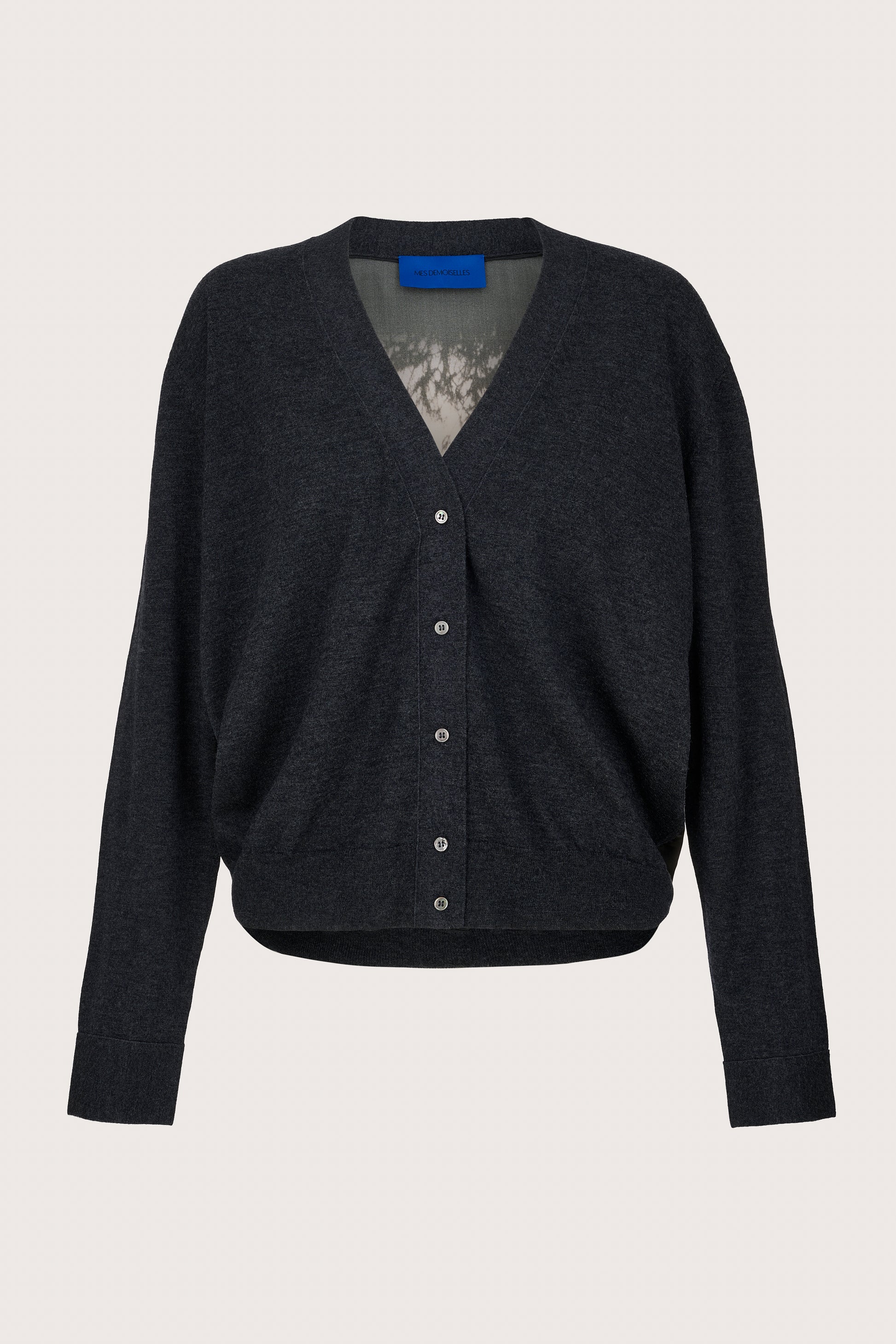 Charcoal cardigan with silk back panel on a light gray background