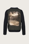 Charcoal grey cardigan with a scenic print of a lake and mountains on the back, displayed on a light gray background.