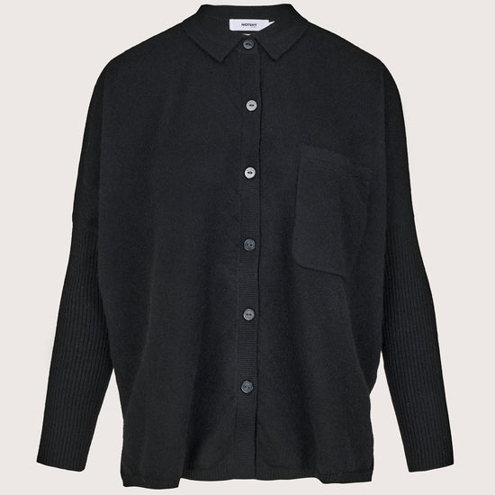 Black cashmere shirt with buttons on a light gray background